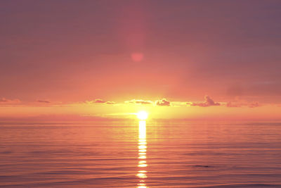 Scenic view of sea against romantic sky at sunset