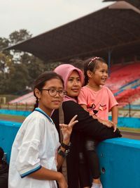 Smiling family looking away in stadium