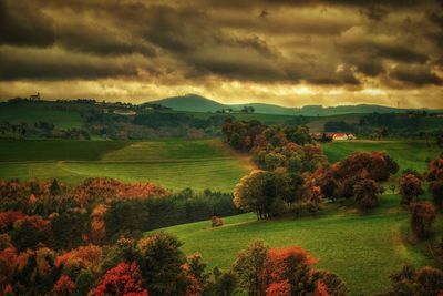 Scenic view of field against dramatic sky