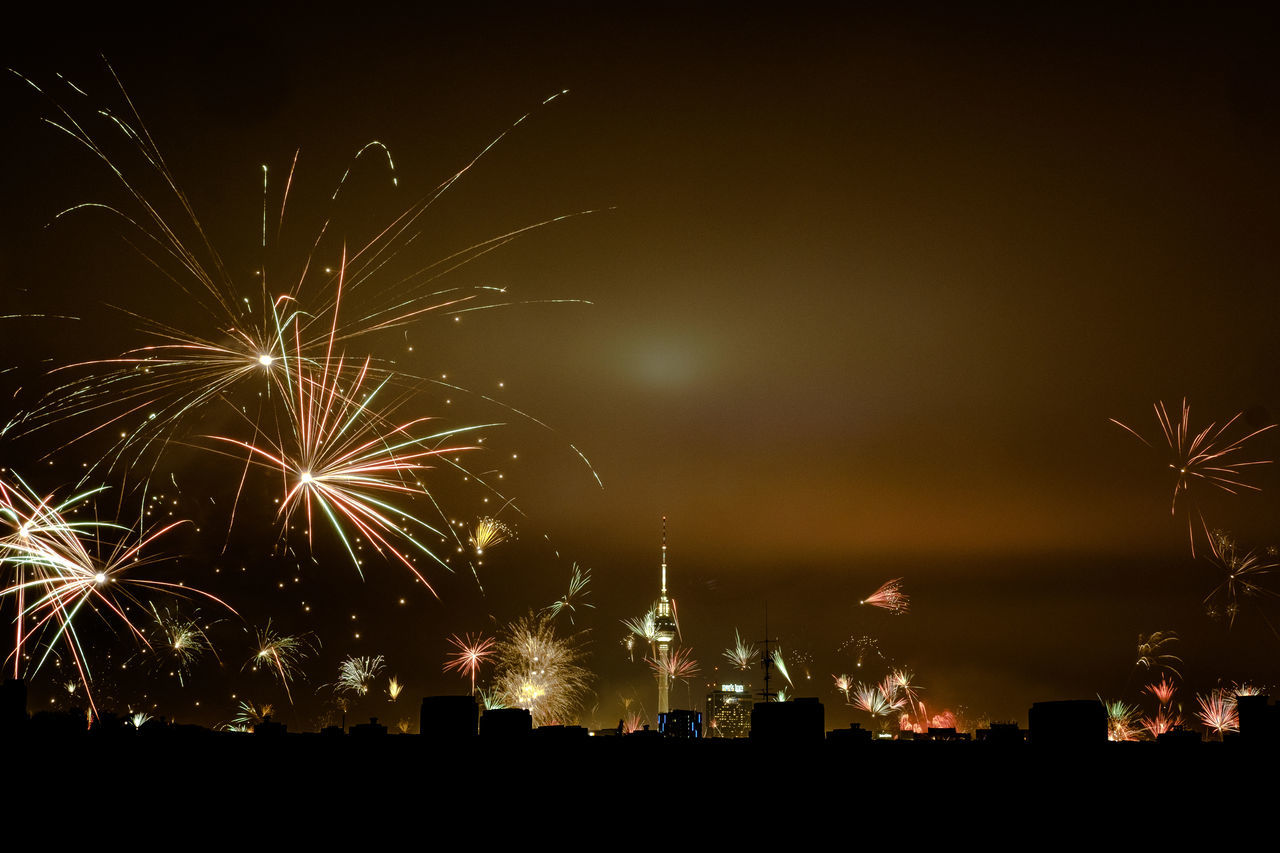 LOW ANGLE VIEW OF FIREWORKS AGAINST SKY AT NIGHT