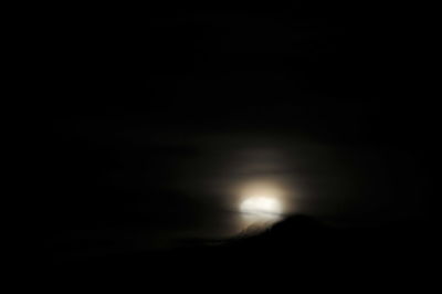 Low angle view of silhouette moon against sky at night