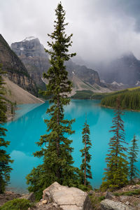 Scenic view of lake by mountains against sky