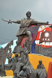 Low angle view of statue against sky