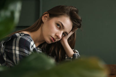 Portrait of young woman looking away outdoors