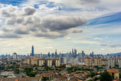 High angle view of modern buildings in city against sky