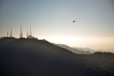 Low angle view of silhouette mountain against clear sky