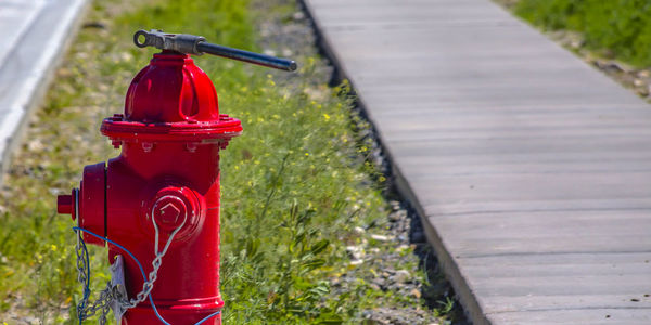 Red fire hydrant on footpath