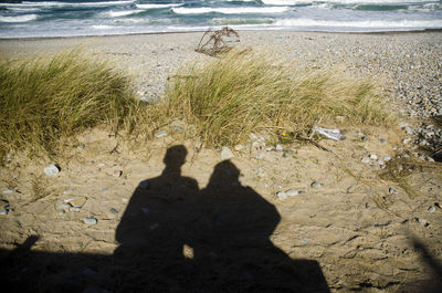 Shadow of people on beach