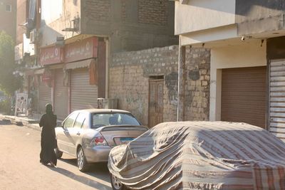 Cars on street by buildings in city