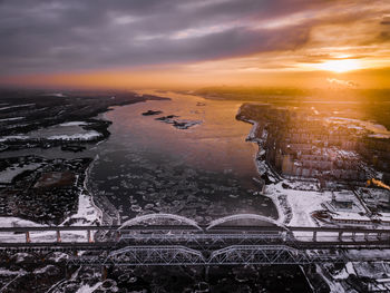 Aerial view of buildings in city during sunset