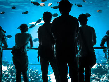 Group of people standing on tiled floor