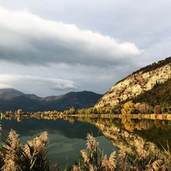 Scenic view of lake and mountains against sky