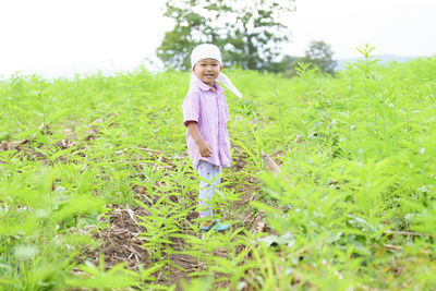 Full length of boy standing on field