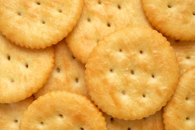 Top view of round crackers, food background.