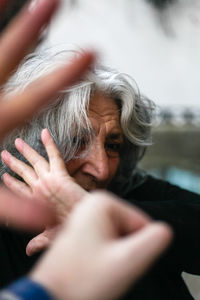 Close-up of young woman being hit by a fist