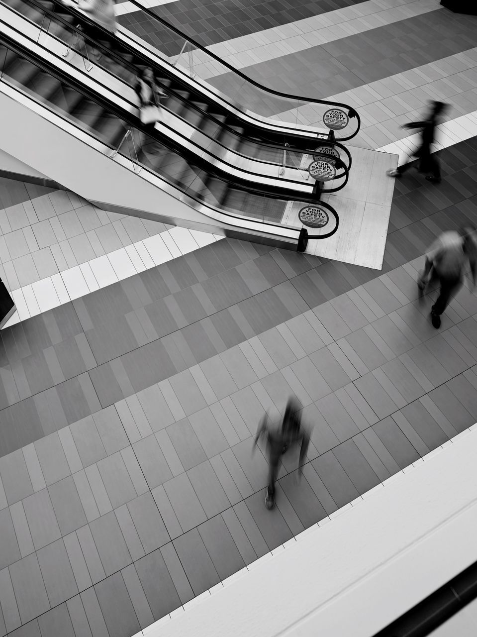 real people, high angle view, walking, motion, blurred motion, men, full length, one person, day, lifestyles, women, indoors, architecture, people