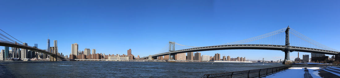 View of suspension bridge against blue sky