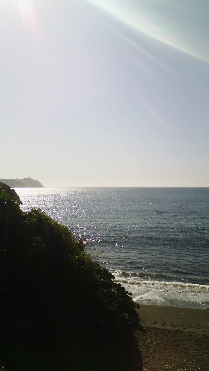 sea, horizon over water, water, tranquil scene, tranquility, scenics, beach, beauty in nature, clear sky, shore, nature, sun, idyllic, copy space, sunlight, coastline, sky, seascape, outdoors, calm