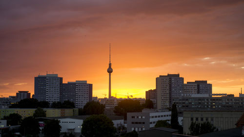 Fernsehturm tower with cityscape against sky during sunset