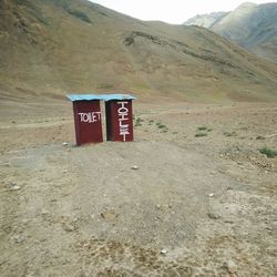 Information sign on landscape against sky