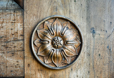 Close-up of an old wood door with an engraved decoration