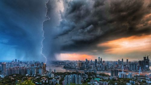 Panoramic view of city against dramatic sky