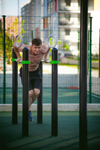 Muscular man exercising at park