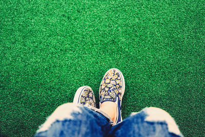 Low section of person standing on field