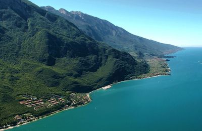 High angle view of lake garda and mountains against sky