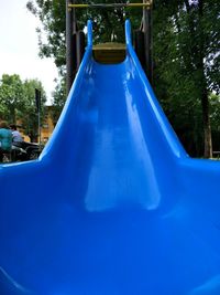 View of swing in park against blue sky