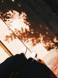 Low section of person standing on tiled floor