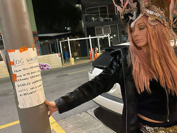 Woman standing on street in city