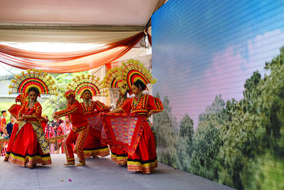Group of people in multi colored umbrella