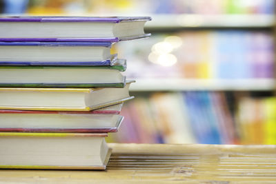 Close-up of colorful stacked books on table