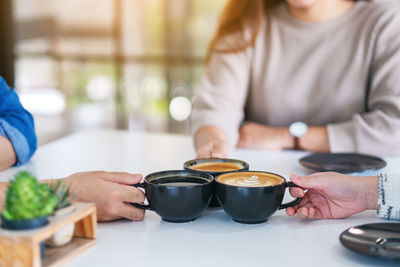 Midsection of woman holding coffee cup