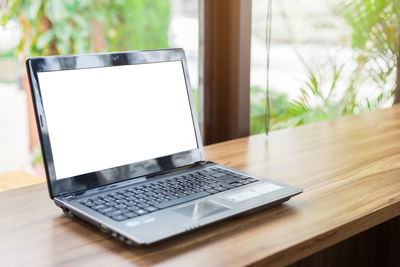 Close-up of laptop on cafe table