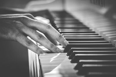 Close-up of hands playing piano