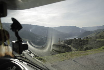 Cars on road against mountain range