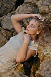 Midsection of woman on rock