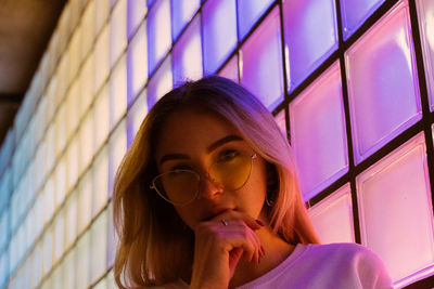 Portrait of woman looking away against window