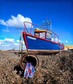 Low angle view of windmill on field against sky