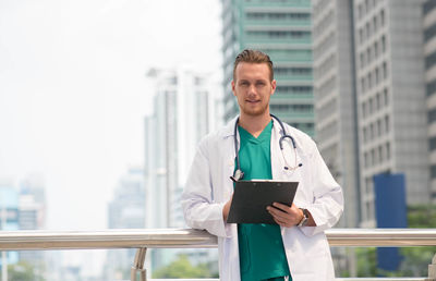 Portrait of doctor standing in city