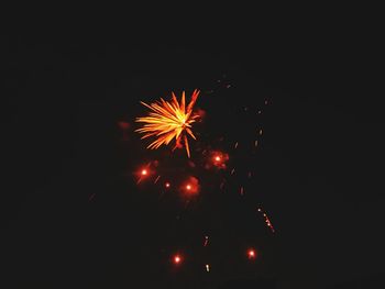 Low angle view of firework display at night