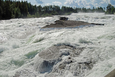 Scenic view of water flowing through rocks