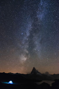 Scenic view of mountain against star field