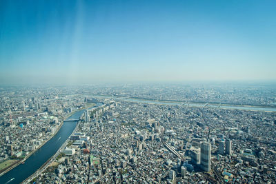 High angle view of crowd by buildings against sky