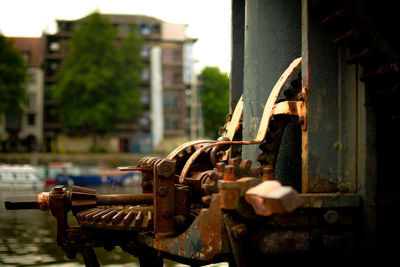 Close-up of rusty machine in city