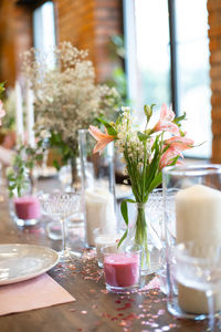 Flowers in glass vase on table