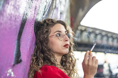 Low angle view of young woman looking away