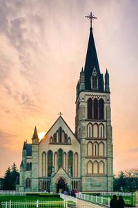 Facade of church against sky during sunset